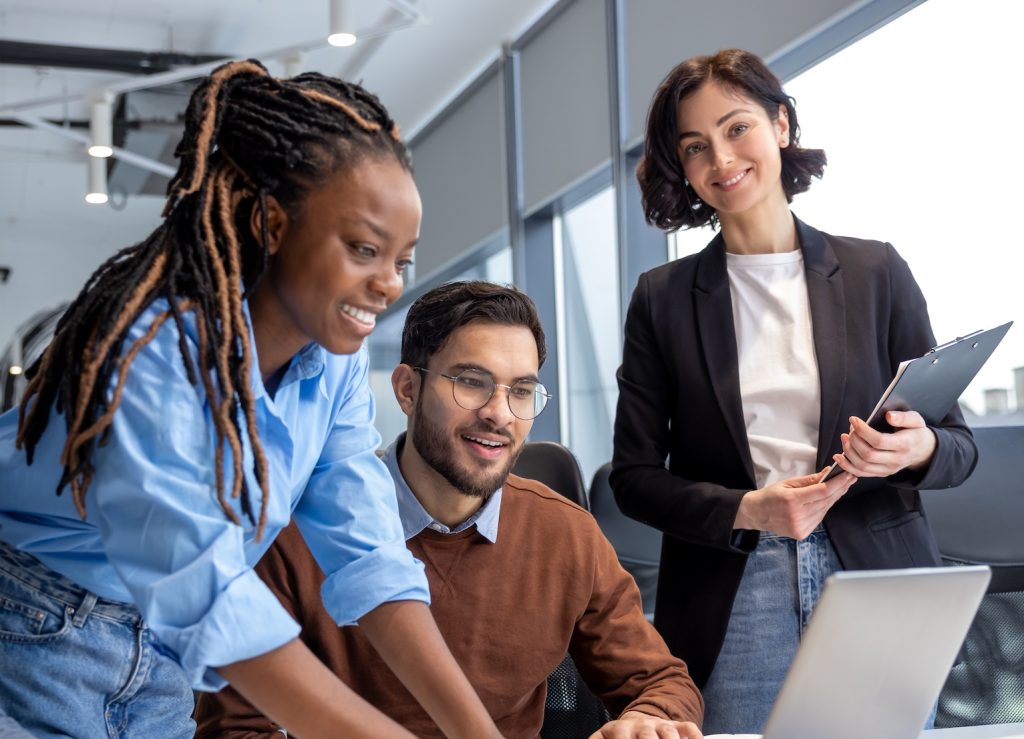 Entrepreneurs,Smiling,While,Sitting,Together,In,A,Co working,Space,Working